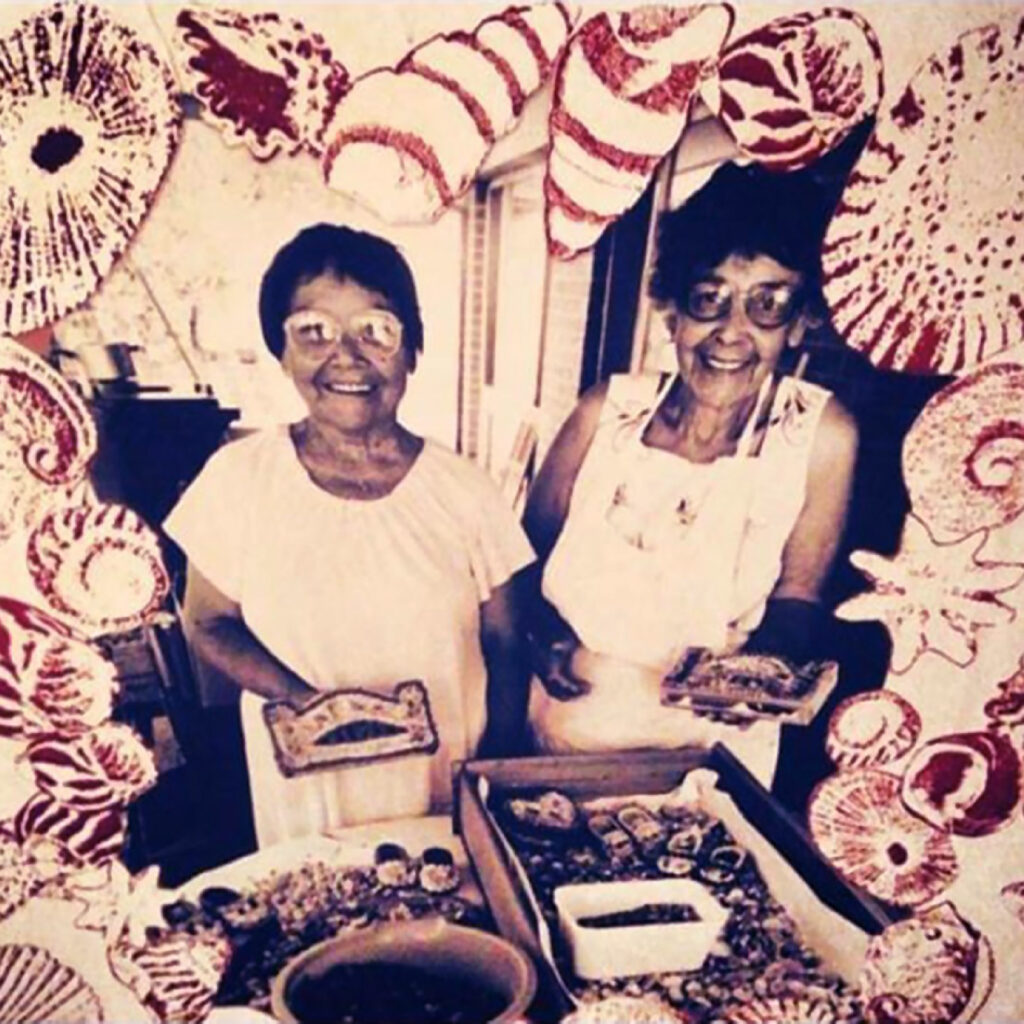 Lola Delia Ryan – a Dharawal woman - and her sister Mavis Longbottom are holding a shellwork model of the Sydney Harbour Bridge in their hands. They are smiling and looking straight at the camera. A tray of shells are in front of them. The border of the image features an array of sketched shells.